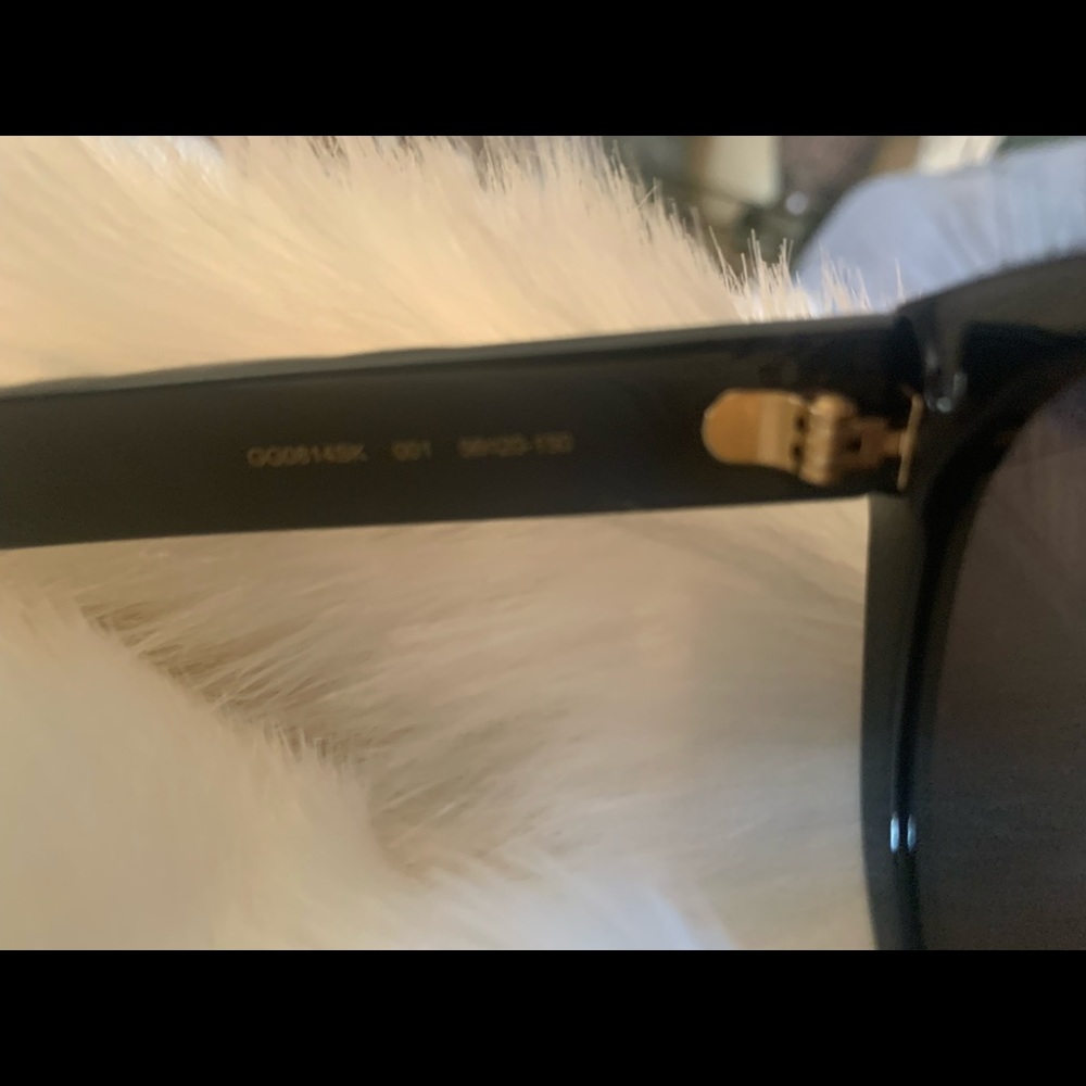 A beautiful pair of Gucci sunglasses new with tags. Black frame